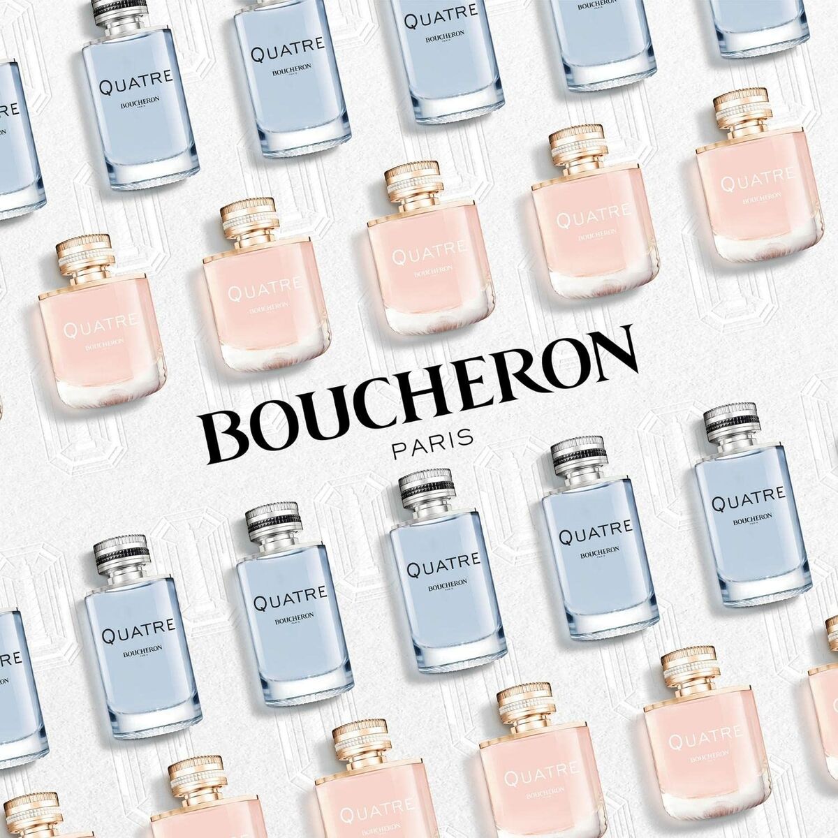 Display of Boucheron Quatre Pour Homme and Quatre Pour Femme perfumes in bottles, featuring Boucheron Paris branding.