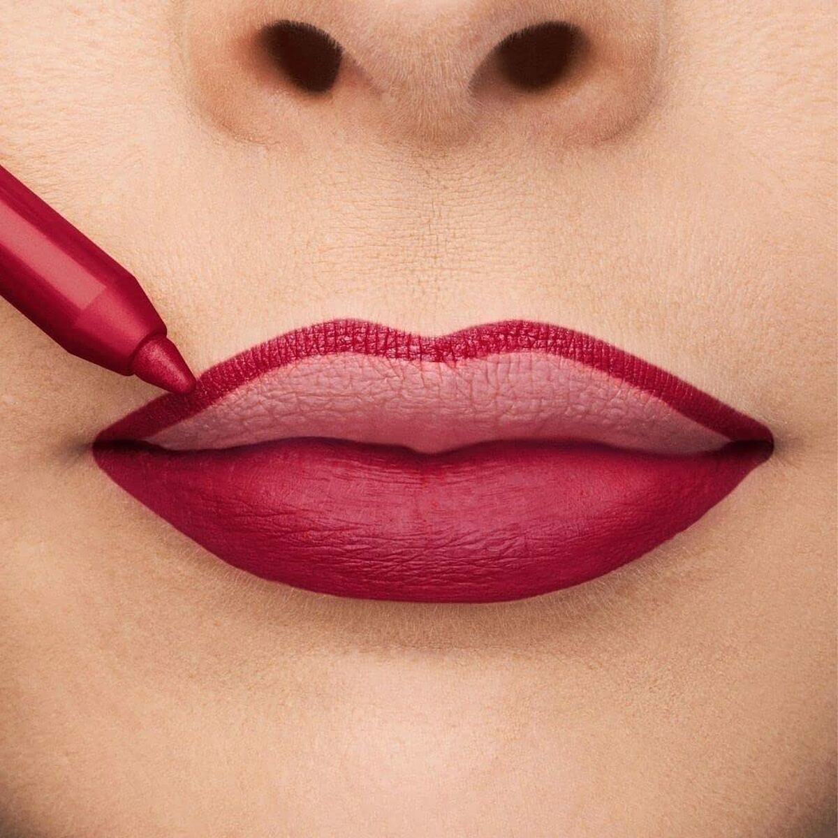 Application of Collistar lip liner in a deep red shade on full lips, enhancing beauty and confidence.